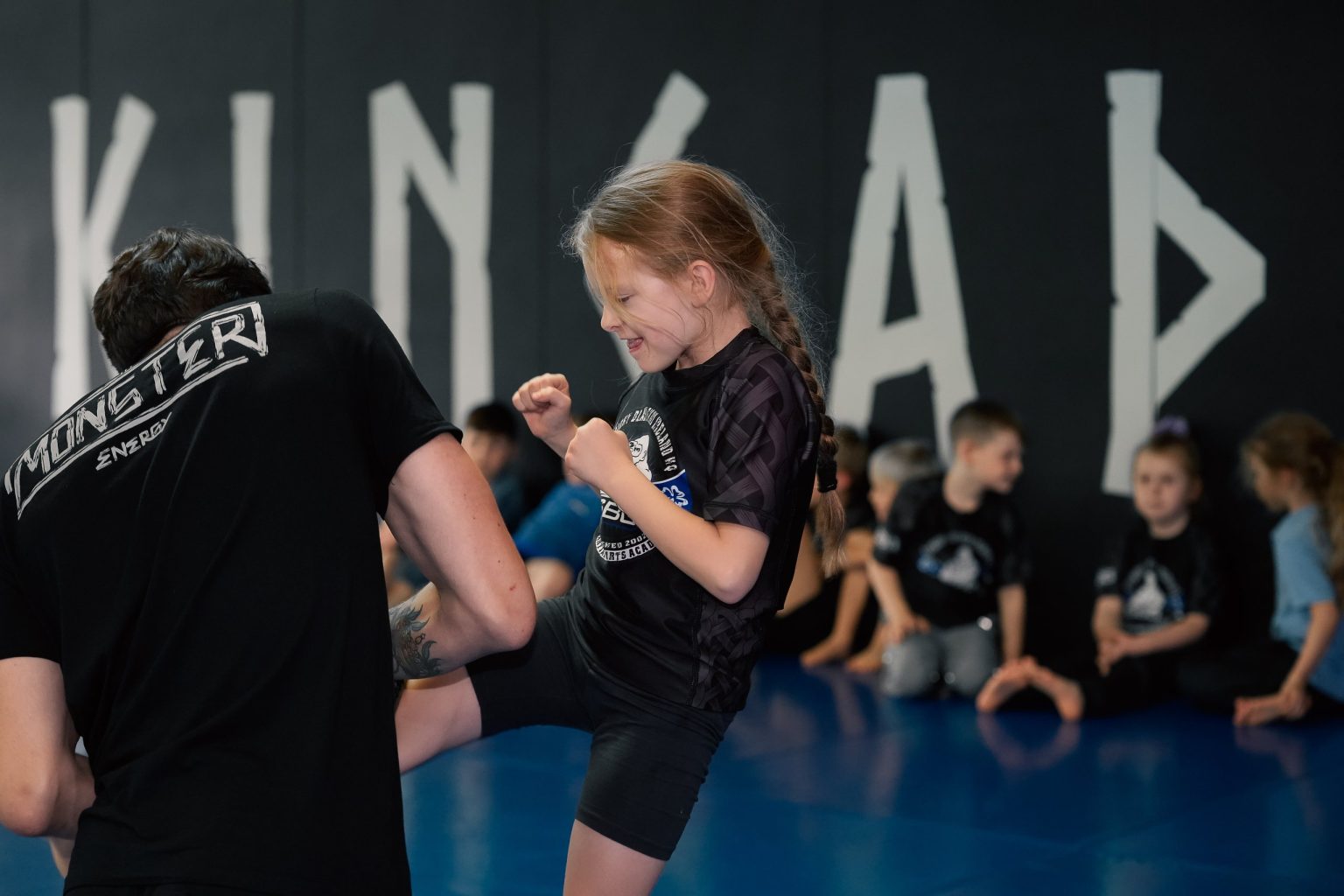 A young SBG Kids member practising kicks on the pads